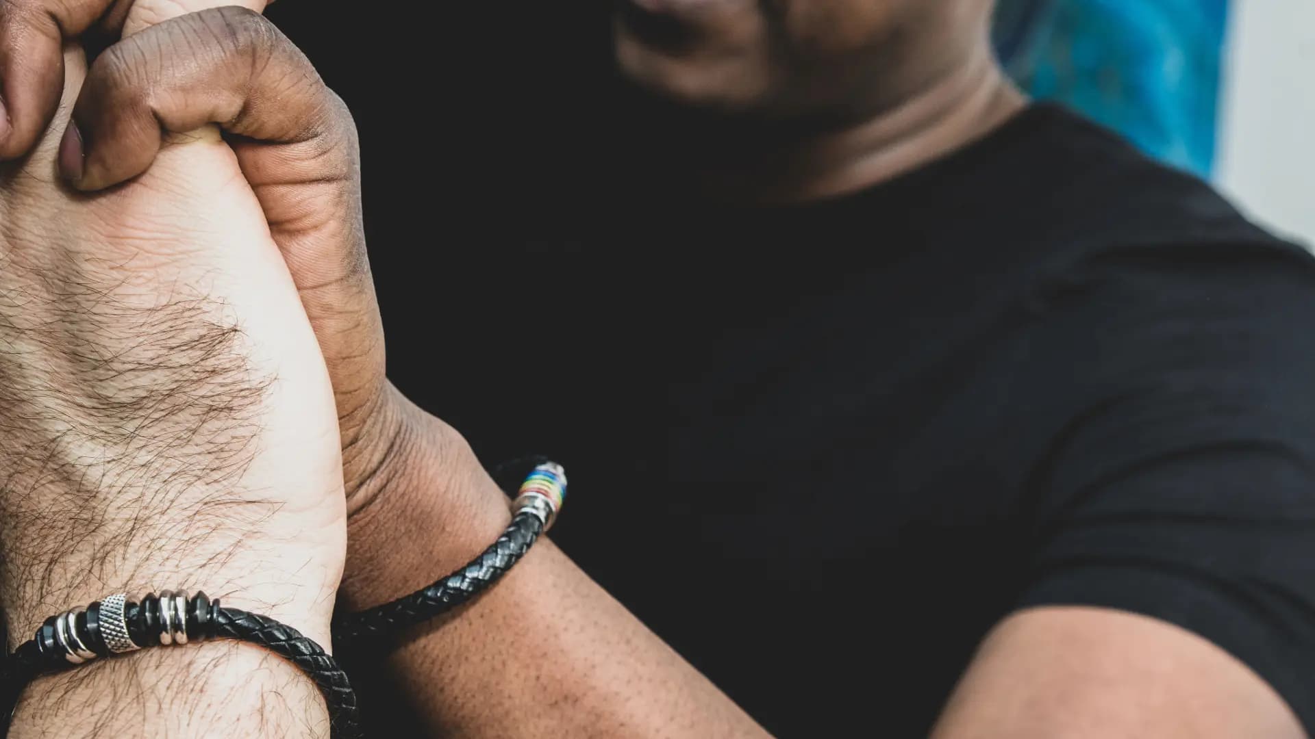 AI-generated image of a person in a wheelchair holding an LGBT flag, symbolizing inclusivity and empowerment for people with different abilities